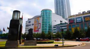 a building with a statue in the middle of a city at An Hotel Jakarta in Jakarta