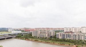 a city with a river and buildings and a bridge at New century Manju Select Hotel Hongqiao Hub National Exhibition Center in Shanghai