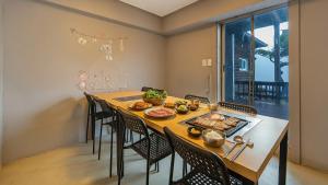 a dining room table with chairs and food on it at Gapyeong Yeheaden Pension in Pocheon