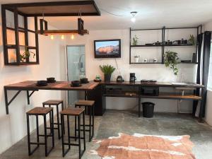 a kitchen with a table and stools in a room at Apartment #4 for 4 Central-WiFi-consulate in Matamoros