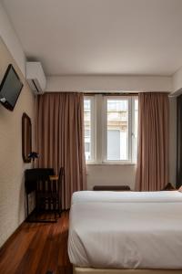 a hotel room with a bed and a window at WOT Porto Soul in Porto +56 photos