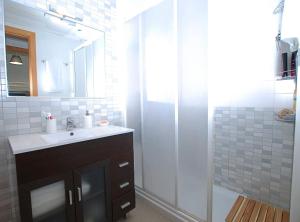 a bathroom with a sink and a shower with a mirror at Petit niu · Petit niu · Apartamento AC - 3 min de la playa in Vilassar de Mar +36 photos