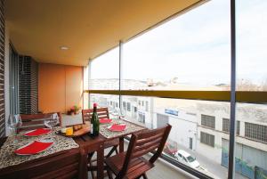 a dining room with a table and a large window at Cozy Home · Cozy Home · Nice apartment w/pool and private terrace in Mataró