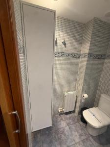 e bagno con servizi igienici bianchi e doccia. di Waves and sky a Montgat