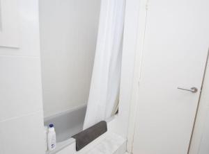 a bathroom with a shower curtain and a tub at Can Josep in Vilassar de Mar +20 photos