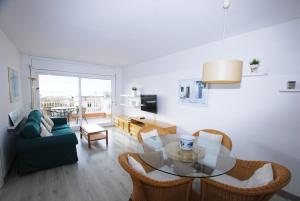 a living room with a table and a couch at Narciso views in Vilassar de Mar