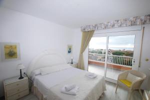 a bedroom with a bed and a window with a balcony at Narciso views in Vilassar de Mar +23 photos