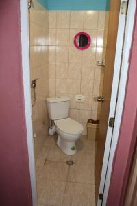 a bathroom with a toilet and a pink window at Hostel Victoria in Silistra +13 photos