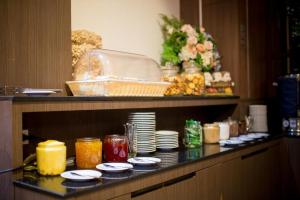 a table with plates and candles on top at Silayok Grand Hotel in Tak +87 photos