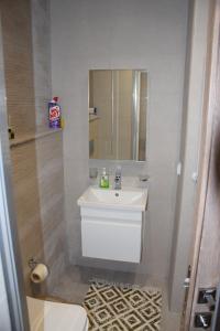 a bathroom with a white sink and a mirror at Fantastic Appartment SeaView Sousse in Akouda
