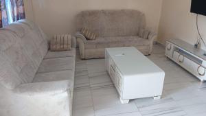 a living room with a couch and a coffee table at 2-bedroom equipped apartment in Bakote