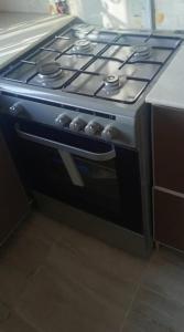 a stove top oven sitting in a kitchen at 2-bedroom equipped apartment in Bakote