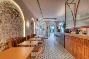 a row of tables and chairs in a restaurant at Nalia Suites in Nafplio
