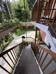 a stairway leading to a garden with flowers and plants at Avocado Orchards - Home Stay in Kenichira