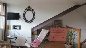 a living room with a staircase and a dresser at Annexe 44 in Nantes