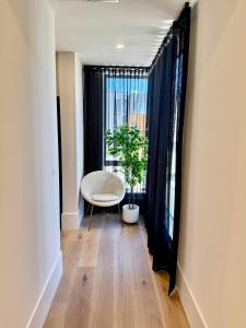 a hallway with a chair and a window at Port Melbourne Marvel in Melbourne +30 photos