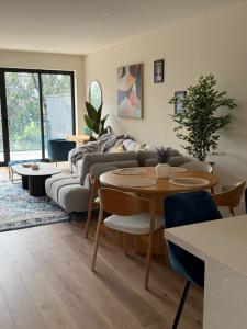 a living room with a couch and a table at Port Melbourne Marvel in Melbourne
