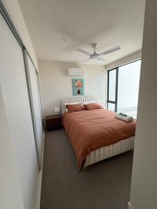 a bedroom with a bed and a ceiling fan at Port Melbourne Marvel in Melbourne