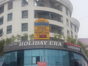 a building with a sign on the front of it at Hotel Holiday Era in Aurangabad