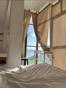 a bedroom with a bed with a view of the ocean at The Ocean Villa in Matara