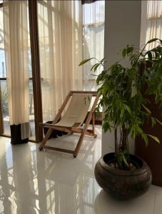 a hammock in a room with a potted plant at The Ocean Villa in Matara