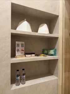 two bottles of water are sitting on a shelf at The Palm hotel & spa in Almaty