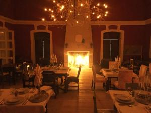 a dining room with tables and a fire place at Zabola Estate - Transylvania in Zăbala