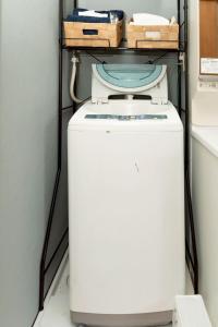a washer and dryer with baskets on top of it at Otsuki in Oishi