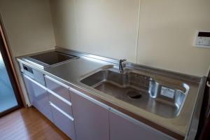 eine Küche mit Spüle und Herd in der Unterkunft Otsuki in Oishi + 23 Fotos