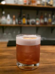 a glass of tea sitting on a wooden table at Hotel Foxtrot Hakuba in Hakuba +32 photos