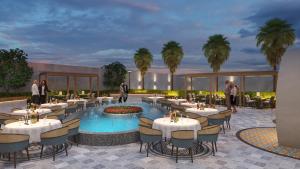 a rendering of a restaurant with tables and chairs at The Sterling Resort in Bhawānīgarh