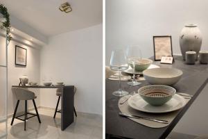 Luxury Kingbed Studio - Estia Premium Apartments في سلانيك: غرفة طعام مع طاولة مع وعاء واكواب للنبيذ