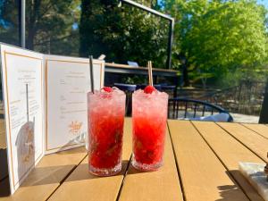 two drinks sitting on a wooden table at Les Restanques pressoir 3029 in Grimaud