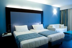 Postel nebo postele na pokoji v ubytování Hotel Napoleon