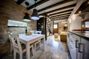 a kitchen with a white table and chairs at RIVA SUITE 2 in Komiža