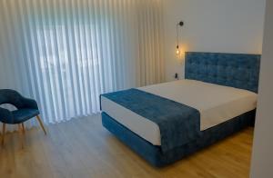 En eller flere senge i et værelse på Coração de Viana AL