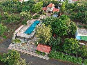 an aerial view of a house with a swimming pool at Neel Farms and Resort in Saoner