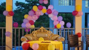 a table with a bunch of balloons and a crown at Neel Farms and Resort in Saoner +75 photos