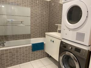 een badkamer met een wasmachine bij Douillet BY DREAM APARTMENTS in Serris
