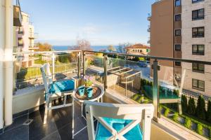 a balcony with a table and chairs and a view at Didi`s Stylish Studio - Seaview & Pool Backyard in Varna City