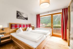 Ένα ή περισσότερα κρεβάτια σε δωμάτιο στο Hotel Steinbock