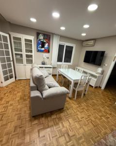 a living room with a couch and a table at Apartments soho, Malaga center in Málaga