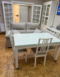 a table and chairs in a living room with a couch at Apartments soho, Malaga center in Málaga