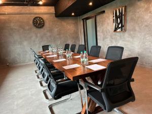 a conference room with a long wooden table and chairs at Sena Hotel Langkawi in Kampung Padang Masirat +25 photos
