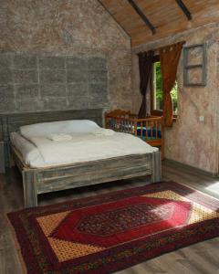 a bedroom with a bed and a rug in a room at Dili Heaven in Dilijan