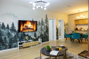 a living room with a fireplace on the wall at Grand Chalet Ramina in Poiana Brasov