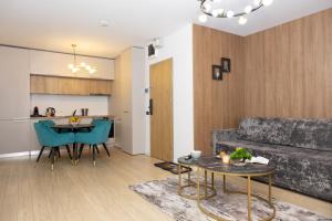 a living room with a couch and a table at Grand Chalet Ramina in Poiana Brasov