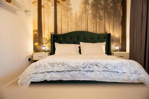 a bedroom with a large bed with two night stands at Grand Chalet Ramina in Poiana Brasov