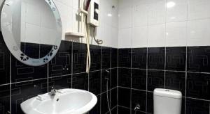 a bathroom with a sink and a mirror and a toilet at Ampang Point Star Hotel in Kuala Lumpur +96 photos
