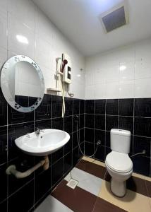 a bathroom with a toilet and a sink at Ampang Point Star Hotel in Kuala Lumpur